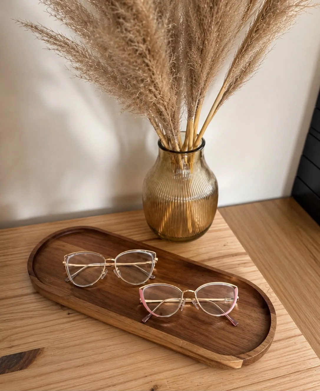Styled eyewear flat lay on a wooden tray